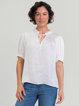 Woman wearing the Smock Neck Blouse by Margaret O'Leary.