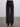 Person wearing the Trish Wide Leg Pant by Margaret O'Leary, a black, high-waisted pant against a plain background.