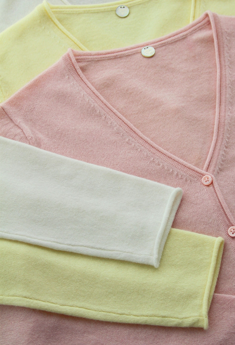 Vignette of cashmere vee cardigans in pastel colours by Margaret O'Leary.
