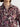 Woman wearing the Shiv Shirt, a floral patterned shirt by Margaret O'Leary, and jeans on a plain background.