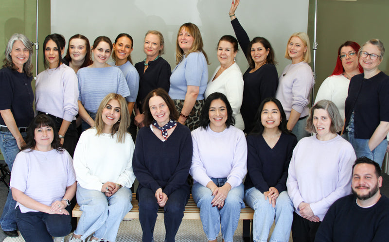 Group of Margaret O'Leary employees wearing matching boucle sweaters.