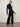 Person wearing the Dimensional Neck, a navy tneck textured sweater by Margaret O'Leary paired with black pants.