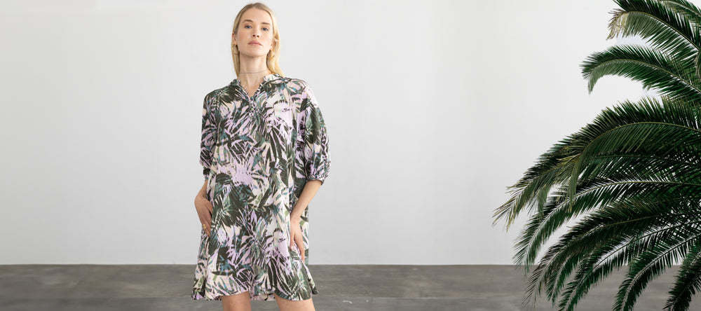 Woman wearing the Paola Dress in Dark Tropical by Margaret O'Leary.