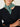 Woman wearing a Cashmere Triangle Scarf by Margaret O'Leary, a green scarf on a plain background.