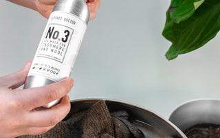 A woman handwashing a cashmere sweater.