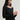 Woman wearing a black Stretch Ballet Tee and grey pants by Margaret O'Leary against a plain background