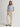 Person wearing parchment Sadie Pants with a matching belt by Margaret O'Leary on a plain background