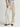 Person wearing parchment Sadie Pants with a matching belt by Margaret O'Leary on a plain background