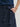 Person wearing a Navy blue Sandra Skirt with a matching belt by Margaret O'Leary on a plain background