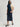 Person wearing a Navy blue Sandra Skirt with a matching belt by Margaret O'Leary on a plain background