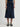 Person wearing a Navy blue Sandra Skirt with a matching belt by Margaret O'Leary on a plain background