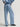 Woman wearing a blue button down Drapey Twill Shirt and matching Drapey Twill Pant by Margaret O'Leary against a grey backdrop.