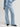 Woman wearing a blue button down Drapey Twill Shirt and matching Drapey Twill Pant by Margaret O'Leary against a grey backdrop.