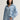Woman wearing a blue button down Drapey Twill Shirt and matching Drapey Twill Pant by Margaret O'Leary against a grey backdrop.