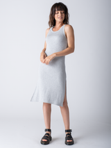 Woman wearing fitted ribbed grey dress. 