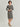 Female model wearing midi grayish greem dress with long sleeves. 