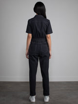 Female model wearing black jumpsuit with belt.