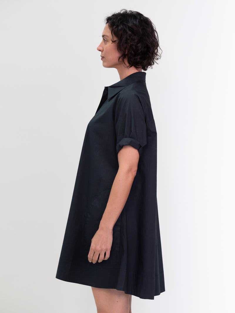 Woman wearing the Voluminous Shirt Dress in Black by Margaret O'Leary.