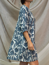 Woman wearing the Paola Printed Dress in Slate Garden by Margaret O'Leary.