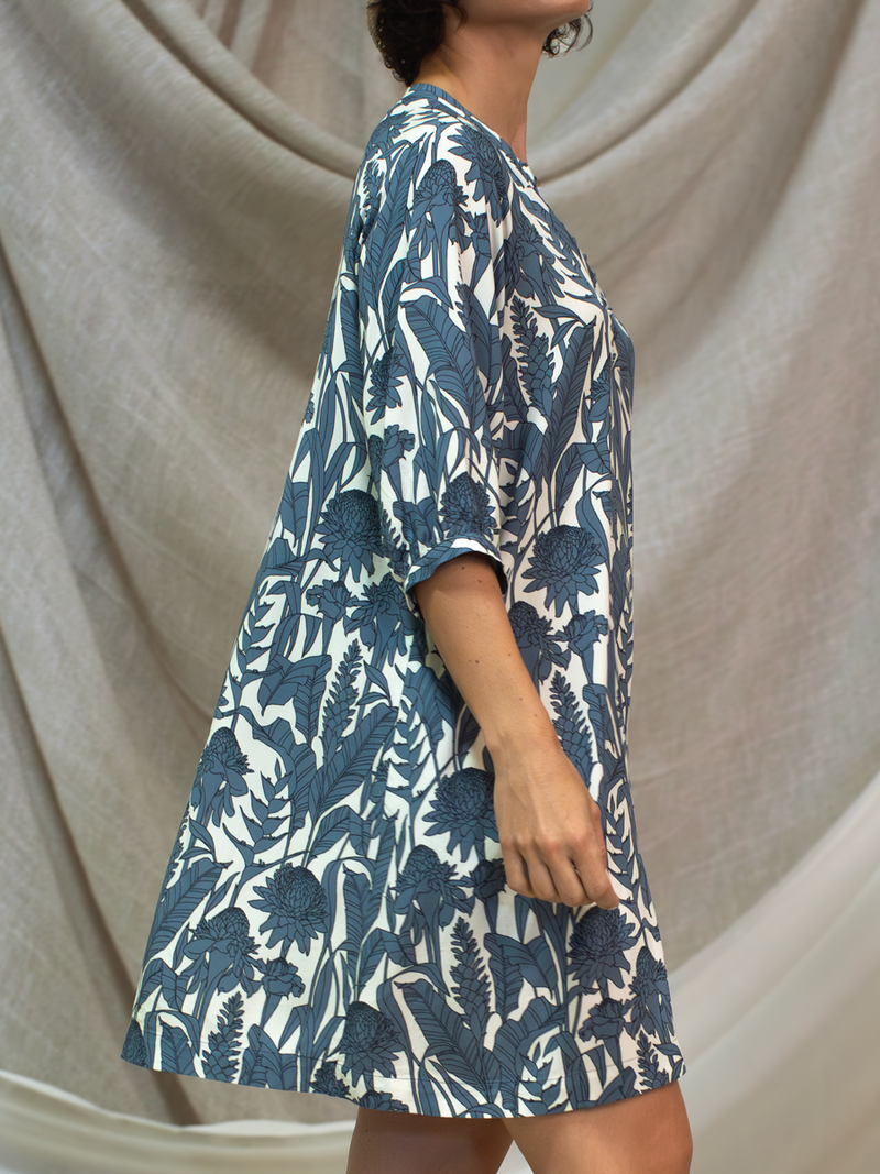 Woman wearing the Paola Printed Dress in Slate Garden by Margaret O'Leary.