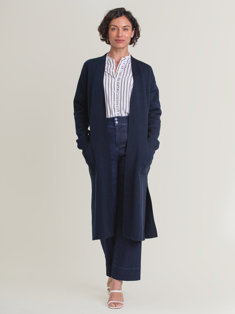 Woman wearing the Midi Belted Coat in Navy by Margaret O'Leary.
