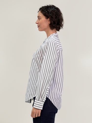 Woman wearing the Ruffle Shirt in Carbon Stripe by Margaret O'Leary.