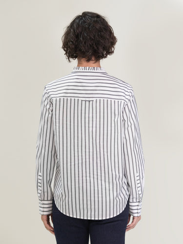 Woman wearing the Ruffle Shirt in Carbon Stripe by Margaret O'Leary.
