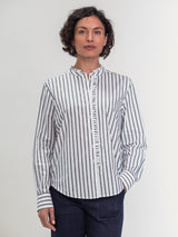 Woman wearing the Ruffle Shirt in Carbon Stripe by Margaret O'Leary.