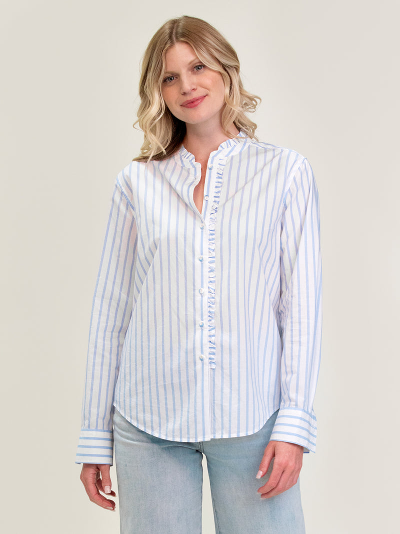 Woman wearing the Ruffle Shirt in Pool Stripe by Margaret O'Leary.
