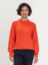 Woman wearing the Lola Pullover in Tomato by Margaret O'Leary.