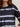 Woman wearing a black and white stripe Tie Dye Long Sleeve Tee by Margaret O'Leary against a plain background