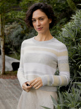 Woman wearing the cashmere pullover in neutral stripes by Margaret O'Leary.