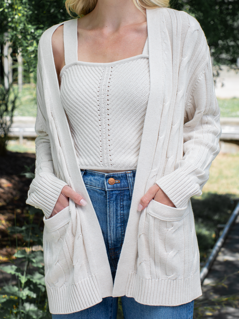 Woman wearing the Nina Cable Cardi in Ivory by Margaret O'Leary.