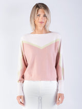 Woman wearing a pink and green cashmere sweater.