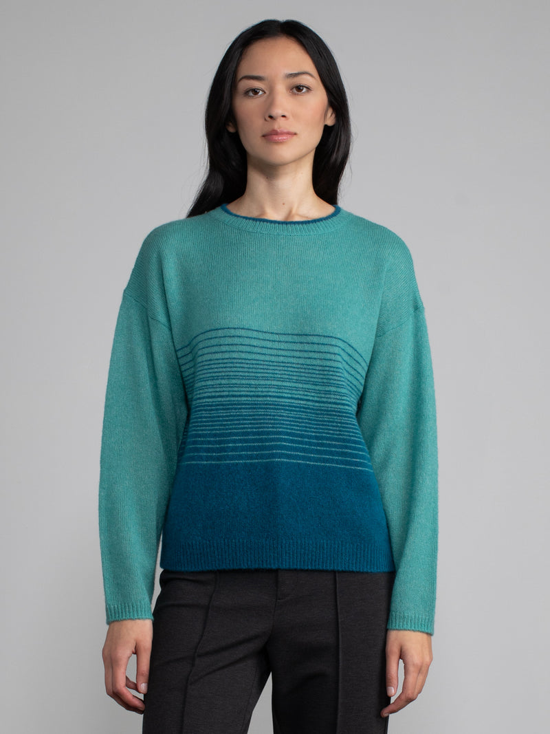 Female model wearing teal cashmere sweater.
