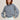 Woman wearing a cotton Navy Stripe Lola Pullover with Teal tipping by Margaret O'Leary against a beige background