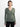 A woman modeling a ribbed long-sleeve V-neck sweater in sage green, paired with black pants, against a plain white studio background.