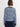 A woman viewed from the back wearing a navy and light blue wavy patterned long-sleeve top with solid navy ribbed trim at the collar, cuffs, and waist.