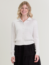 Woman wearing the Emmylou Cable Cardi in ivory by Margaret O'Leary.