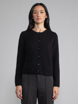 Front view of model wearing black cashmere cardigan.