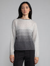 Female model wearing light grey cashmere sweater.