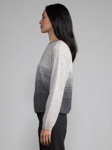 Female model wearing light grey cashmere sweater.