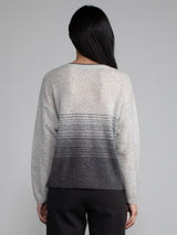Female model wearing light grey cashmere sweater.
