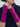 Close-up of Cashmere Texting Gloves by Margaret O’Leary, magenta fingerless gloves styled with a navy knit poncho.