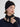 Woman wearing a Double Cashmere Beanie by Margaret O’Leary, a black knit hat styled with a navy sweater and black scarf tied at the neck.