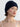 Woman wearing a Double Cashmere Beanie by Margaret O’Leary, a navy knit hat styled with layered gold necklaces on a plain background.
