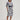 Woman wearing a navy and white floral Emilia Caftan Dress by Margaret O'Leary on a plain background