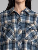 Woman wearing a plaid button down.