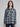 Woman wearing a plaid button down.
