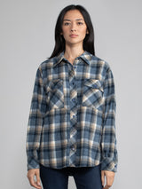 Woman wearing a plaid button down.